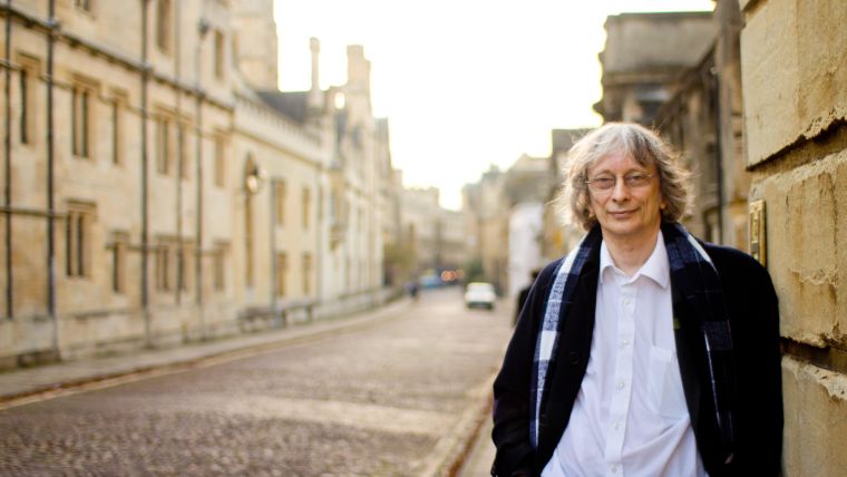 Photo of David Deutsch standing in an Oxford street