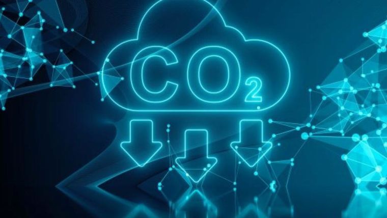 Graphic in shades of blue, showing the chemical symbol CO2 in a cloud shape with three arrows underneath it, pointing downwards, and a series of interconnecting dots and lines to indicate systems and networks. Source: Shutterstock