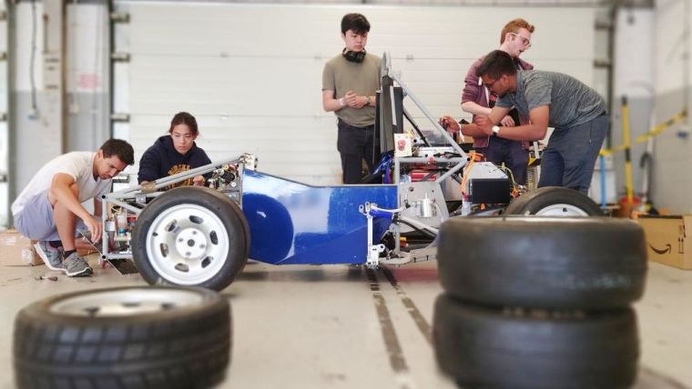 Oxford students working on the finishing touches to their electric race car