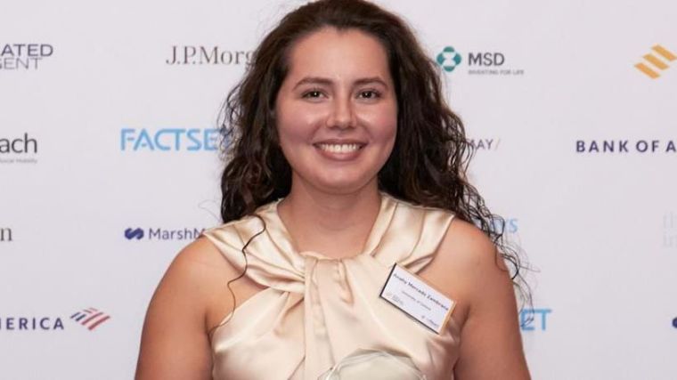 Anahy Mercado Zambrana pictured wearing a dress and name badge at the upReach Student Social Mobility Awards 2022, against a backdrop of award sponsor logos