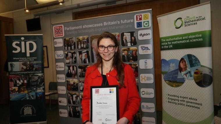 Desi Ivanova with her award at the STEM for BRITAIN competition