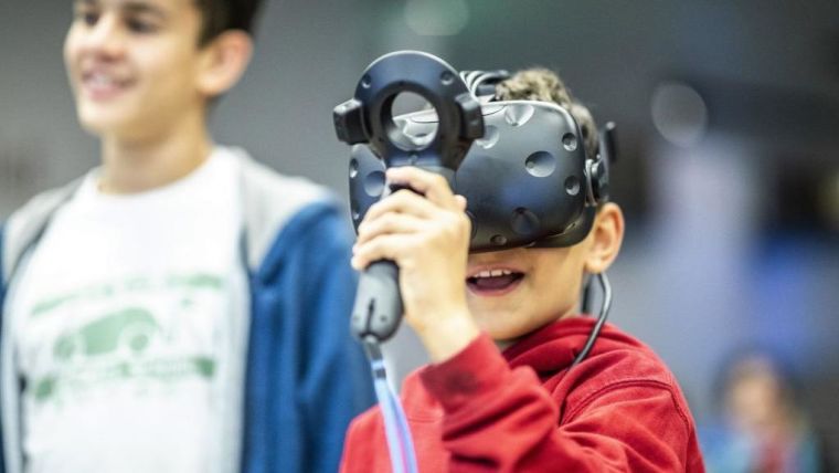 A young science festival participant trying out a virtual reality headset