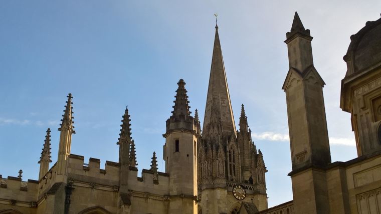 Spires of Oxford buildings, against a blue sky