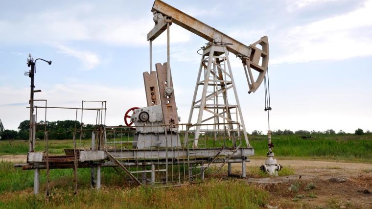 An old oil pump jack on an oil field in the United States