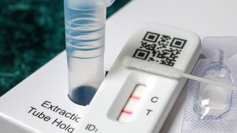 Close-up of rapid Covid-19 home lateral flow antigen test with positive result